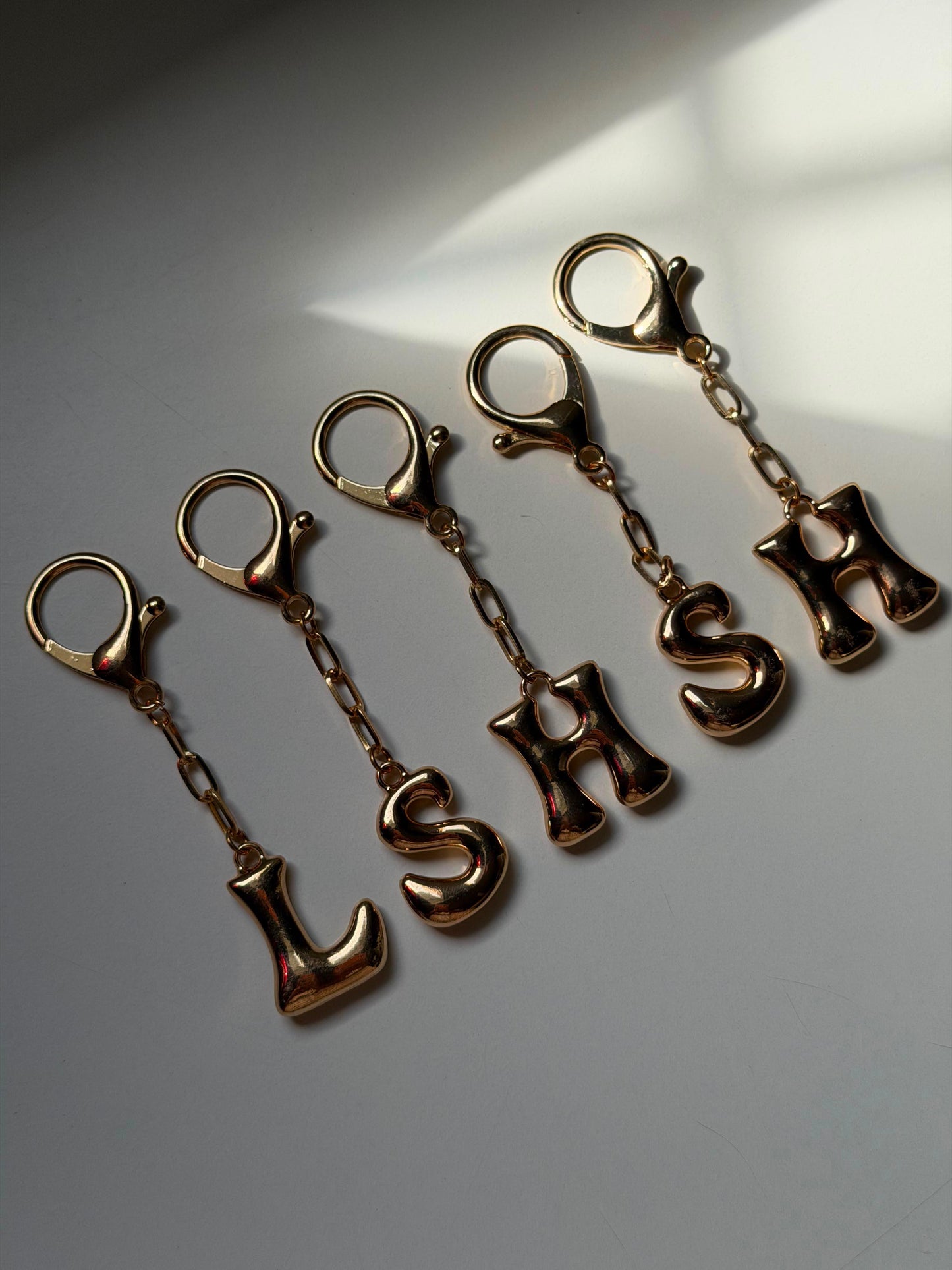 Alphabet’s gold bubble charm bag keychain