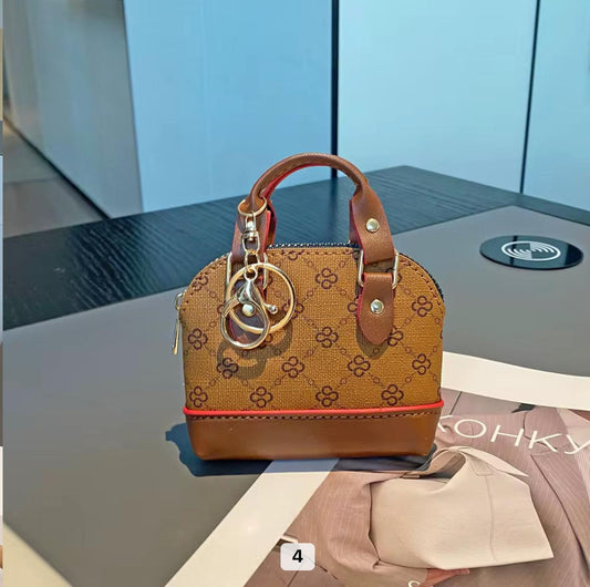 Tan/beige monogram with brown leather base and handle Mini bag  charm key chain