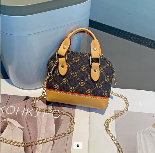 Dark brown monogram with tan leather accents and gold chain strap Mini bag  charm key chain